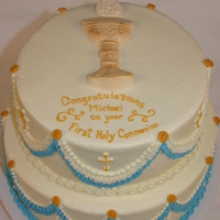 Chalice First Communion Cake Tiered chocolate cake with raspberry buttercream filling and white chocolate chalice and host. Thanks for looking!