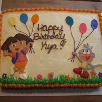 Dora Decorations made with fondant, piped buttercream grass.