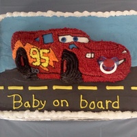Cars Baby Shower Cake 12x18 cake with Wilton Lightening Mc Queen cake on top. Car is star tipped with a pacifier in his mouth. Cars cake and bottom cake are iced...