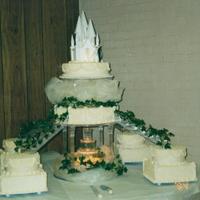 Cake For 600 Princess castle in the clouds. All cakes are real and covered in buttercream and cornelli lace. Four satellite cakes are routes to the...