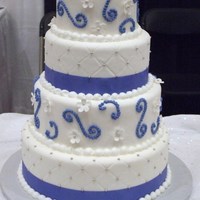 Wedding Cake Round Wedding cake covered in fondant with quilted pattern and fondant flowers