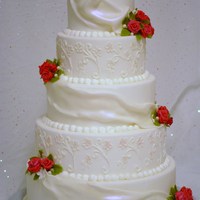 Wedding Cake Round wedding cake covered in fondant, with fondant roses, and drapes