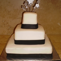 Shooting Stars 3 tier square vanilla cake with raspberry filling. Covered in white MMF trimmed with black MMF.