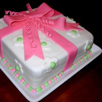 Present Cake My cake from the 3rd Wilton course. Fondant covering and bow with royal icing dots. First time with fondant.