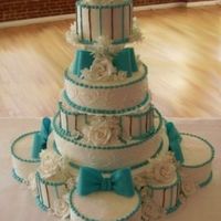 Trythi.jpg wedding for 200 guests14 tiers made up of 3 layers eachGumpaste flowers and bows2 hour set up whew!