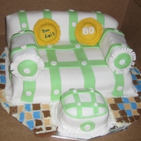 Sofa Couch Made out of orange pound cake. Covered in MMF. For an uncle's 80th birthday.