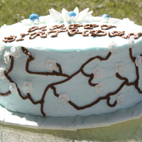 Blue Ad White Cherry Blossoms I made this cake for my mom's birthday. It's a French vanilla cake, with raspberry filling. Covered in buttercream. The daisies...
