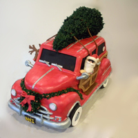 Woody Christmas Cake This is a sculpted cake make of fondant and royal icing with gingerbread cookie wheels.