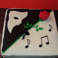 Phantom Of The Opera Square cake with white modeling chocolate mask and silk rose.