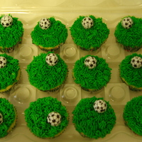 Soccer Cupcakes yellow cake with green buttercream frosting. store bought chocolate soccer balls