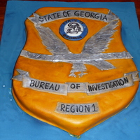 Gbi Badge I made this for my husband for an office dinner. It was two sheet cakes, cut and carved, covered in fondant, and painted with diluted gel...