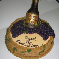 Wine Bottle In Basket Of Grapes Wine bottle in basket of grapes. Red Velvet cake with cream cheese icing. Label on wine bottle is fondant.