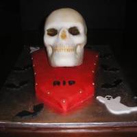Skull Cake Used the Wilton Skull pan. The glaze they recommended for the cake just looked awful so i chipped it off and covered the skull with white...