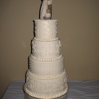 Elegant Ivory Wedding Cake The bride wanted something understated, but not entirely plain, with a monotone color scheme in ivory. Cake Tiers: 12" WASC with...