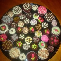 Sany0051.jpg Red Velvet cupcakes with fudge & cream cheese frostings. Decor. in same, plus buttercream, plain & toasted coconut, chocolate chips...