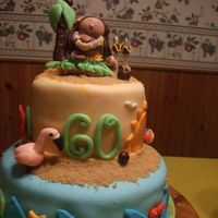 6Oth Birthday Luau Cake This is a Pina Coloda Cake, with mmf, hula girls body is gumpaste. I don't think I put enough buttercream under the fonadant, that&#...