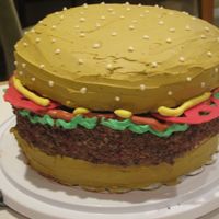 12Th Birthday Hamburger Cake My son wanted his 12th birthday cake to be a hamburger - buns are yellow cake, patty is devils food. Buttercream icing with tomatoes made...
