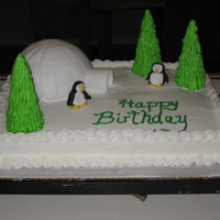 Penguin Birthday Cake Yellow sheet cake with buttercream. The igloo was 1/2 a chocolate ball cake covered in fondant. Trees were sugar cones layered with royal...