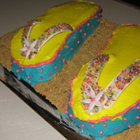 Flip Flop Birthday Cake Yellow cake with buttercream. Straps are fondant with sugar sparkles. Made for our office monthly birthday party.