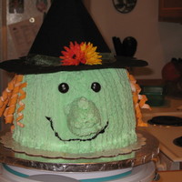 Halloween Witch Three layer yellow cake with BC. The hair is fondant curls, eyes are Junior Mints and the nose is a twinkie covered in BC. Done for my...