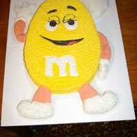 M&m Cake Carved cake w/BC frosting & rice crispy arms, legs & conversation bubble.