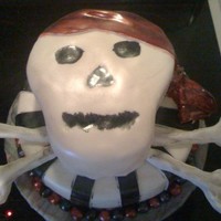 Skull/pirate Fondant covered cake. Top layer was carved and covered with fondant to look like a skull. All color was hand painted and then airbrushed...