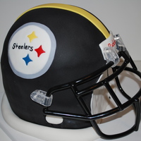 Steeler's Football Helmet This is for my nephews 10th bday. This is his favorite NFL team. All vanilla cake covered with fondant. Face mask is real because I didn&#...
