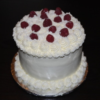 White Chocolate Raspberry Cake Triple layer 6 inch white chocolate cake with raspberry filling. Buttercream icing and white chocolate shavings and fresh raspberries.