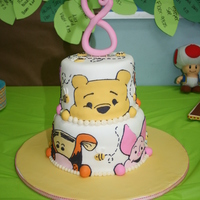 Pooh Bear cakes are 8" and 6", covered in fondant. Faces are made of fondant with black royal icing outlines