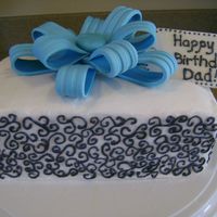 Birthday Present Cake Snickerdoodle cake filled with cinnamon frosting and Buttercream icing. Outside of cake was frosted with buttercream and topped with...