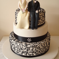 Black And White Wedding Cake. A variaion of a popular theme this time with sugar figures. All the piping is freehand.