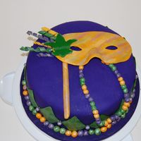 Mardi Gras Cake This was a cake for a final in a fondant class I took. It is an almond cake with bavarian filling. It is covered in fondant and all...