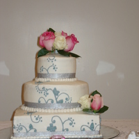 Silver, White, & Pink Wedding Cake Butter Pound Cake with Strawberry Cream-Cheese filling, buttercream icing & silver scroll work. Fresh pink & white roses and satin...