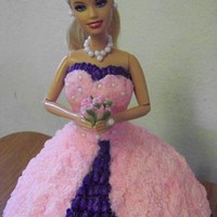 Barbie Wonder pan sitting on a 8" chocolate cake. Full size Barbie I wrapped in saran wrap. Had fun making it but wish I would have had more...