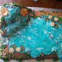Luau Made for a baby showe. 2 11x15 cakes and a 10" square carved for the waterfall. Buttercream with fondant flowers and piping gel to...