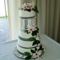 Spring Wedding Cake my sons wedding cake.first attempt at decorating. sugar lillies and leaves.painstakeingly hard to do but i think the overall effect is nice...