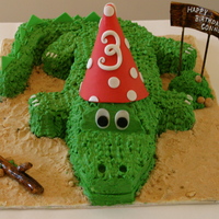 Cute Crocodile! Vanilla cake and vanilla buttercream. Some Fondant accents, but mostly fondant free! Vanilla wafer sand on the board