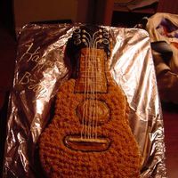 Guitar my son wanted a guitar cake, but wanted a peanut butter icing my grandma used to make, the only way to do it is with a star tip, (wont hold...