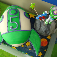 Buzz Lightyear Rocketship For my son's 5th birthday. The bday boy loved it, so I'm happy :-) Rice krispie treat moon and rocketship made from a football...
