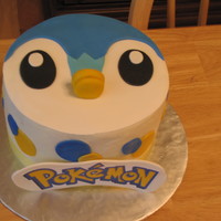 Pokemon Piplup Piplup cake , iced in buttercream with fondant decorations - the POKEMON is printed then placed on gumpaste.