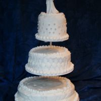 White Wedding Top Tier- devil's food, buttercream icing, buttercream fondant, silver balls in clusters, buttercream stringwork Middle Tier- White...