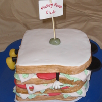 Mickey Mouse Club Cake measures roughly 7.5 inches square. The bread is cake, everything else is fondant - tons of fondant!
