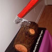 Lumberjack Log And Ax French Vanilla cake with raspberry filling, buttercream icing airbrushed to look like bark. Cut ends are fondant with airbrush tree rings....