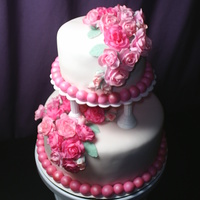 Course 3 Finale Cake Chocolate cake with raspberry flavoring added to fondant. Fondant flowers handpainted with luster dust.