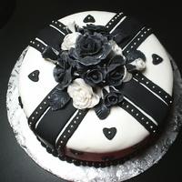 My Sister's Anniversary Cake Chocolate cake with Satin Ice fondant. Gumpaste roses with silver luster dust, and silver dragees.