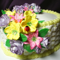 Floral Explosion Spice cake torted with cream cheese filling and vanilla BC basketweave. Fondant roses, royal icing lillies, petunias and ladybug with lots...