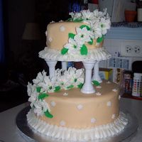 Wilton Course 3 Final Cake This is a tiered cake made with lots of large and small lillies and leaves.