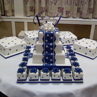 Hearts And Bows This was my dirst wedding cake. The main cake is polystyrene dummies just for show. The 20 mini cakes were for the bridal party as gift...