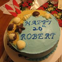 Img_1142.jpg This is a beach themed cake, all BC with chocolate sea shells and graham cracker crumbs for the sand, the surfboards were made of wood,...
