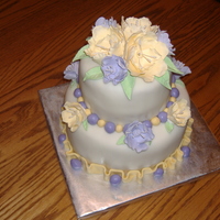 Fantasy Flower Cake Pale yellow and lilac fantasy flowers on white fondant cake